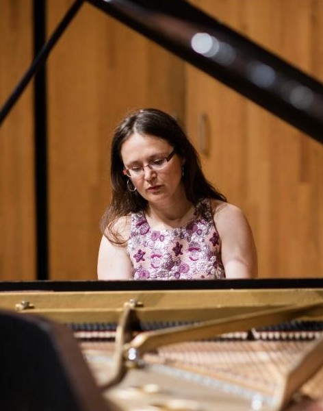 Ann DuHamel seated at the piano